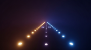 cash-runway-hero - SaasCEO.com - SaasCEO.com Dark scene with two glowing runway-like lines of lights, orange on the left and blue on the right, converging at the horizon.